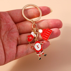 Christmas Santa keychain with red gloves and striped hat charms in gold alloy
