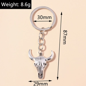 Detailed view of vintage silver bull skull keychain with size and weight measurements