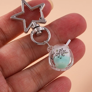 Luminous coffee cup keychain with star clasp and glow-in-the-dark liquid effect