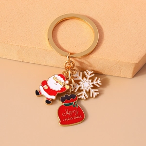 Detail of Christmas keychain with Santa, snowflake, and Merry Christmas gift bag charms
