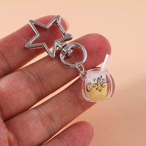 Detailed view of creative luminous coffee cup keychain with star-shaped metal clasp