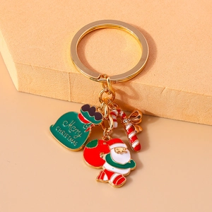 Detail of Christmas keychain with Santa Claus, gift bag, and candy cane charms