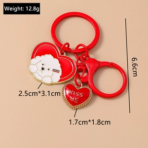 Detail of red heart keychain with cartoon dog pendant and KISS ME charm, 12.8g weight
