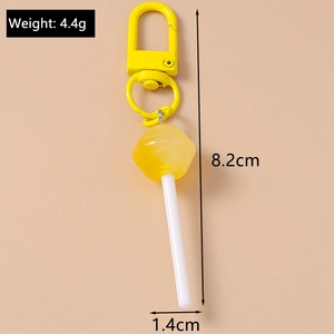 Detail view of yellow lollipop keychain showing dimensions 8.2x1.4cm and weight 4.4g