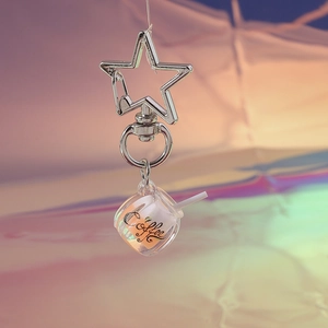 Detailed view of creative luminous coffee cup keychain with silver star-shaped metal ring