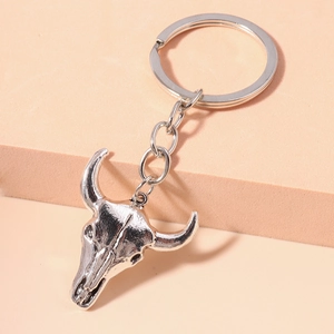 Close-up of vintage silver bull skull keychain with detailed metal texture and ring