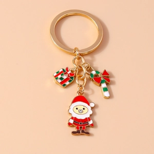 Detail of Christmas keychain with Santa, gift box and candy cane enamel charms
