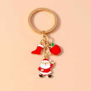 Detail of Christmas keychain with Santa Claus, apple and stocking charms on gold base