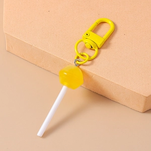 Close-up of a cute yellow lollipop keychain with a matching metal swivel lobster clasp