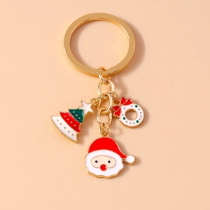 Detail of Christmas keychain with Santa Claus, tree and wreath charms on gold chain