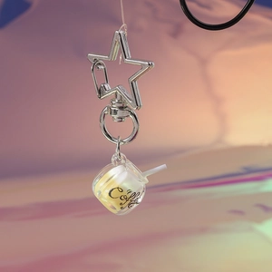 Close-up of luminous coffee cup keychain with star clasp and glowing acrylic detail