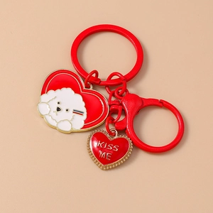 Red heart keychain with white bichon dog pattern and Kiss Me engraved gold pendant