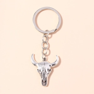 Macro shot of vintage buffalo skull keychain with metallic silver finish and rustic texture