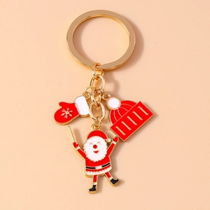 Detail of Christmas Santa Claus keychain with red glove and hat enamel charms on gold ring
