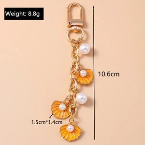 Detailed view of starfish shell keychain with measurements and gold alloy hardware