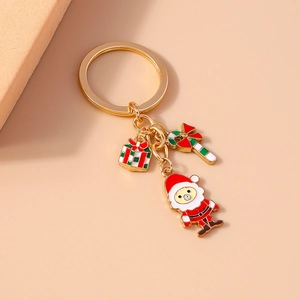 Detail of Christmas Santa keychain with enamel gift box and gold-plated alloy charms