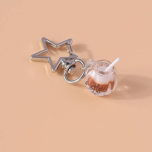 Detailed view of creative luminous coffee cup keychain with star-shaped silver metal clasp