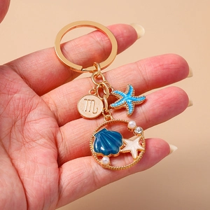 Ocean themed keychain with starfish, blue shell pendant and Scorpio zodiac sign charm