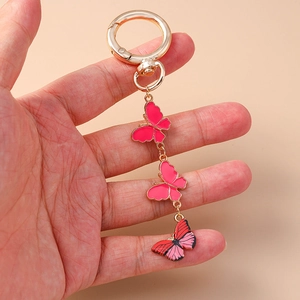 Porte-clés papillon doré avec breloques en émail rose pour décoration de sac à dos