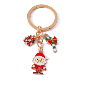 Golden Christmas keychain with Santa Claus, candy cane and gift box charms on white background