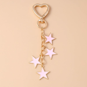 Detail of pink enamel star charms on a golden heart-shaped lobster clasp keychain