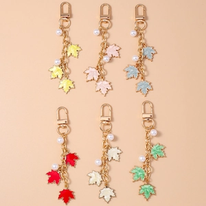 Creative pearl and enamel maple leaf keychain set in six vibrant colors for bags and phones