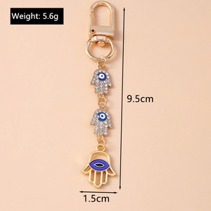 Golden Evil Eye Fatima hand keychain with blue enamel and rhinestones, length 9.5cm