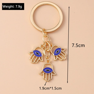 Detailansicht der Hamsa-Hand-Schlüsselanhänger mit Goldlegierung und Emaille-Augen
