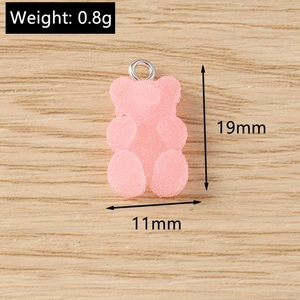 Macro view of a 19mm pink resin gummy bear pendant showing detailed size measurements