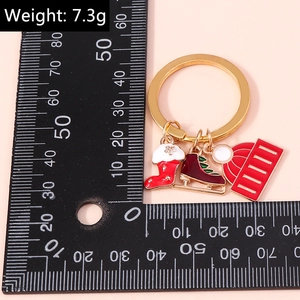 Detailed view of 7.3g Christmas keychain with enamel charms of sock, skate and hat