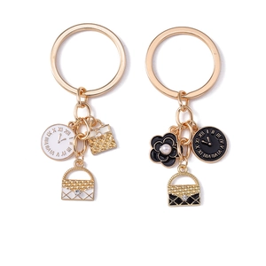 Cartoon clock keychain with camellia flower and mini bag charm in gold alloy finish