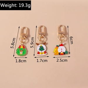 Detailed view of Christmas keychains with wreath, glass ball, and Santa charms