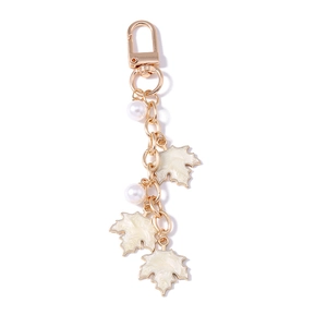Golden maple leaf keychain with white pearls and elegant leaf pendants for bags