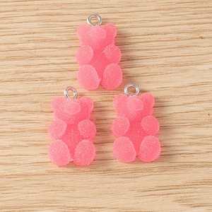 Three pink resin gummy bear charms with sugar texture and silver loops for DIY jewelry