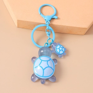 Detail view of light blue resin sea turtle keychain with unique white marble texture pattern