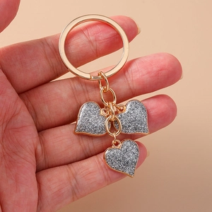 Golden heart keychain with silver glitter charms on metal ring and chain