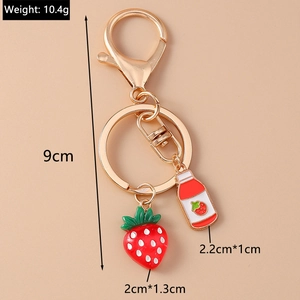 Detailed view of 9cm strawberry keychain with enamel charms and golden lobster clasp
