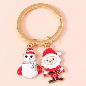 Festive gold Christmas keychain featuring Santa Claus and snowman enamel charms with rhinestones