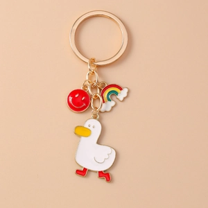 Detail of cartoon duck keychain with rainbow and smiley face enamel pendants