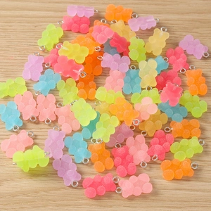 Macro detail of colorful gummy bear resin charms with sugar-like frosted texture and metal rings