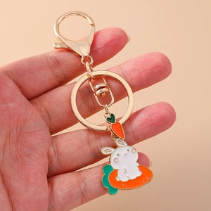 Cute cartoon rabbit on carrot keychain with gold lobster clasp held in hand