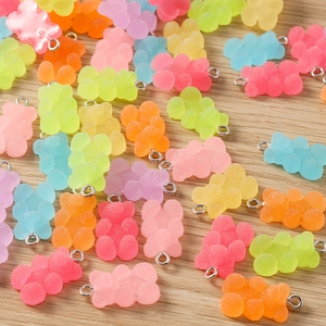 Macro shot of colorful resin gummy bear charms with textured sugar-like finish for DIY crafts