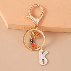 Detail view of cartoon rabbit and carrot keychain with gold lobster clasp and ring