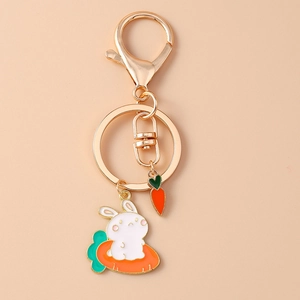 Detail of cartoon rabbit holding carrot keychain with lobster clasp and gold metal ring
