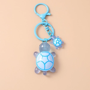 Detail of blue lobster clasp and resin turtle charms on creative animal keychain