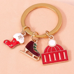 Detail of Christmas keychain with gold ring, festive stocking, ice skate and hat charms