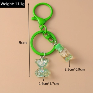 Detail of cartoon resin bear keychain with drift bottle showing 11.1g weight and 9cm length