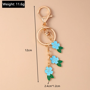 Macro shot of blue cherry blossom keychain showing 12cm length and 11.6g weight details