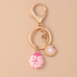 Close-up of pink doughnut keychain with bow and gold-plated alloy lobster clasp hook