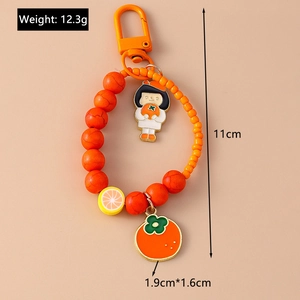 Detailed dimensions of orange fruit keychain with cute girl charm and beaded strap